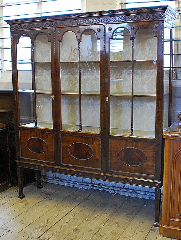 Appraisal: EARLY TWENTIETH CENTURY ADAMS STYLE MAHOGANY DISPLAY CABINET the moulded