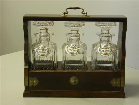 Appraisal: th century mahogany and brass mounted three bottle tantalus with