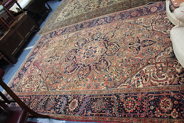 Appraisal: A PERSIAN HORITZ RED GROUND RUG central floral motif geometric