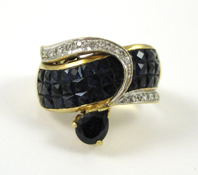 Appraisal: SAPPHIRE DIAMOND AND EIGHTEEN KARAT GOLD RING with facet-cut dark