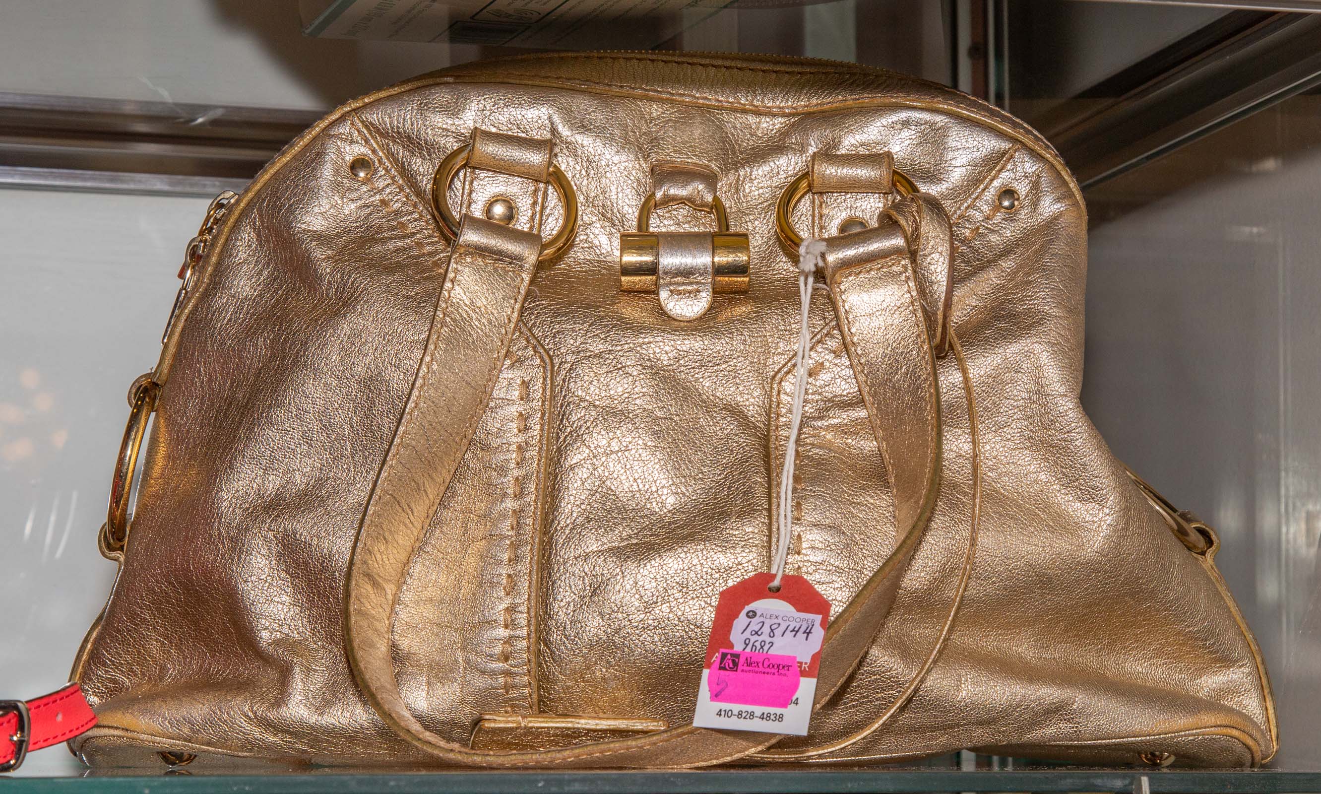 Appraisal: YVES SAINT LAURENT GOLD LEATHER HANDBAG in H in W