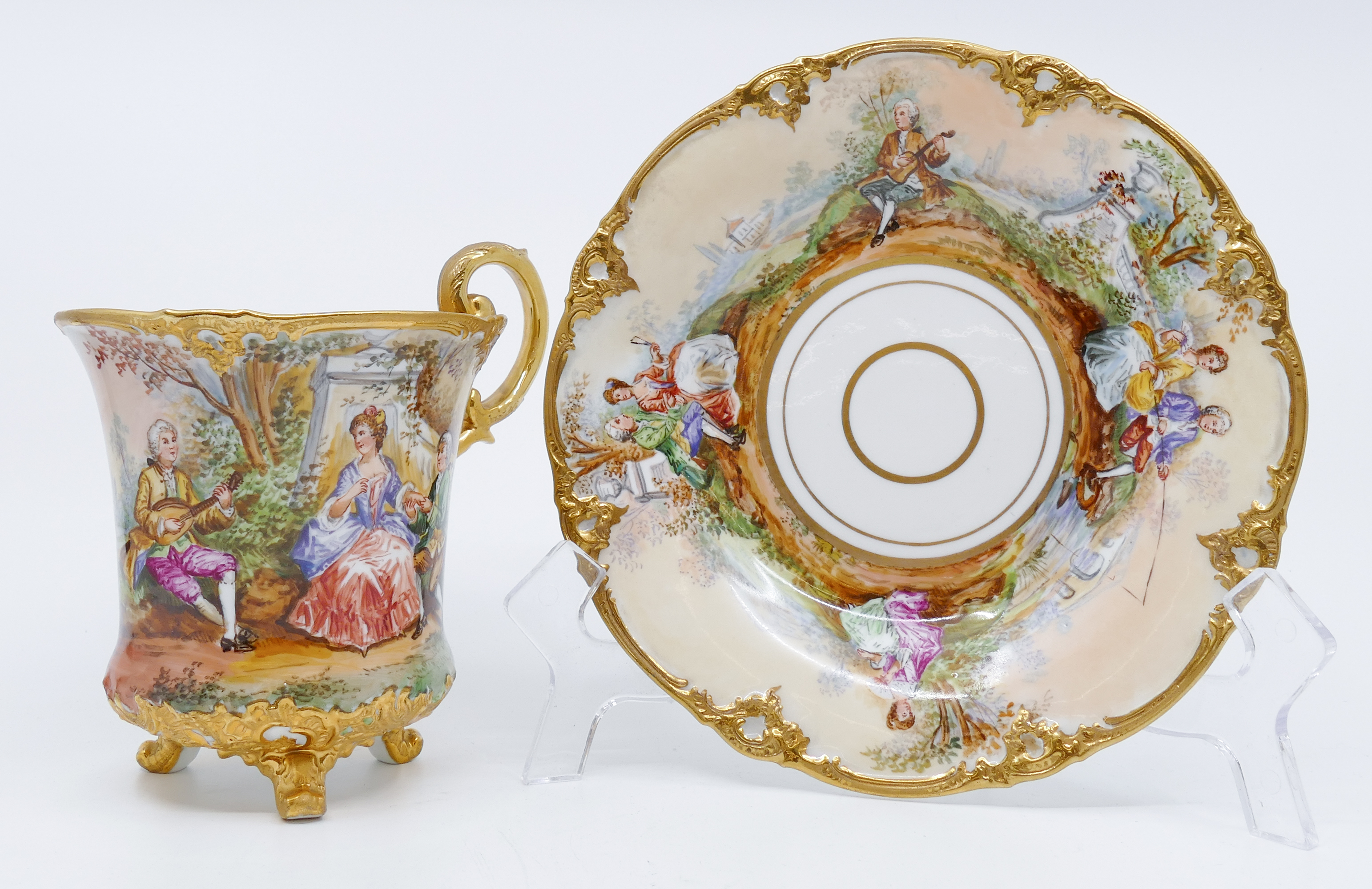 Appraisal: Meissen Courting Scene Pictorial Large Footed Cup Saucer Gilt edges