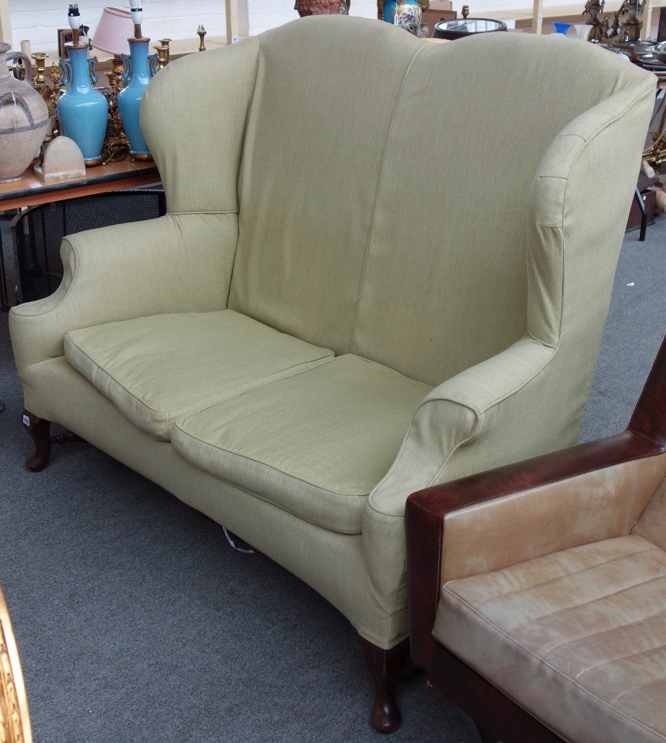 Appraisal: A Queen Anne style high wingback two seat sofa with