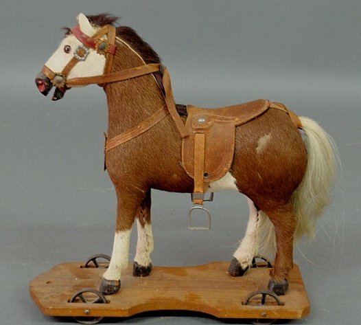 Appraisal: Small child s horse pull toy with hide covering wood