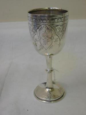 Appraisal: A VICTORIAN GOBLET the ovoid bowl chased with foliate strapwork