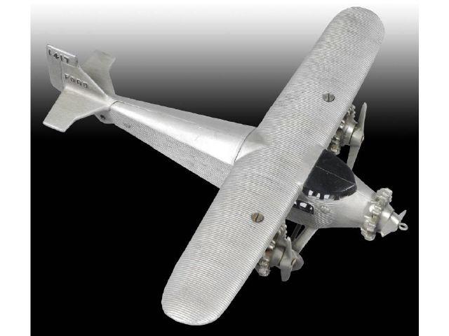 Appraisal: Cast Iron Dent Tri-motor Airplane Toy Description Silver Tail marked