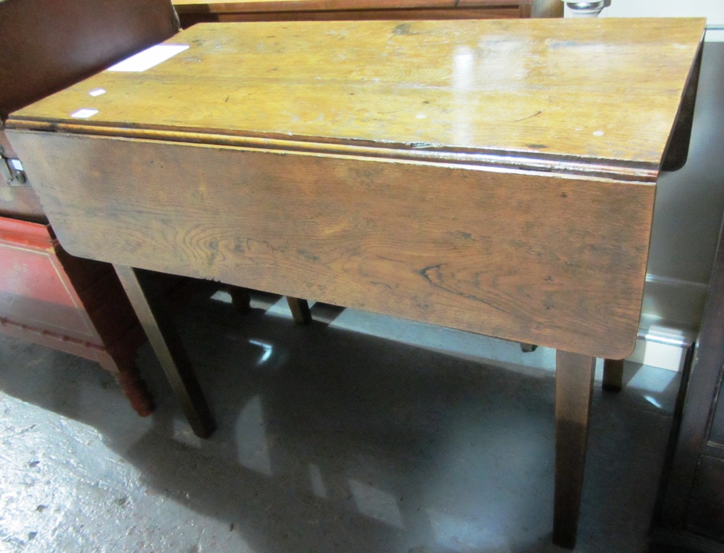 Appraisal: A George III oak drop flap table