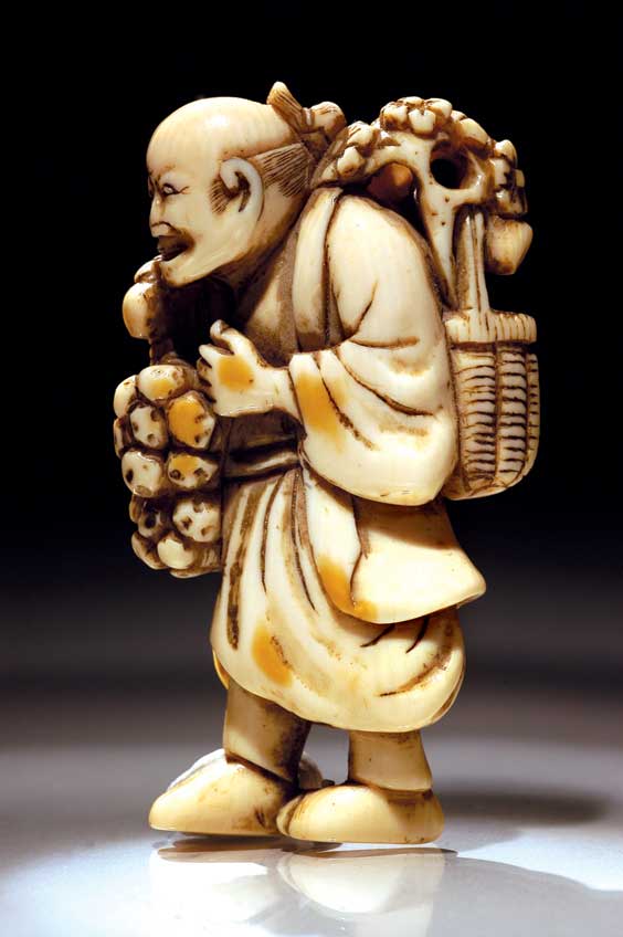 Appraisal: ANTIQUE IVORY NETSUKE Antique carved ivory netsuke of a walking