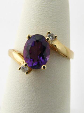 Appraisal: k yellow gold oval amethyst by-pass ring with round diamonds