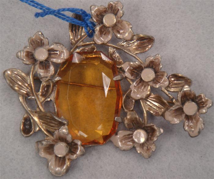 Appraisal: Flower spray brooch featuring large amber colored center stone Estimate