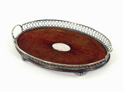 Appraisal: An oval oak tray with a plated open ring gallery