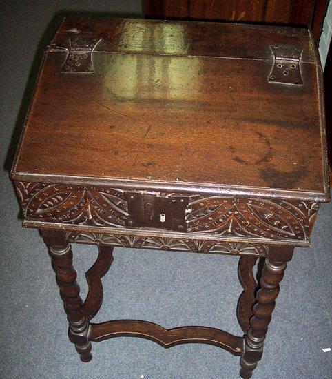 Appraisal: A carved oak bible box the interior fitted three drawers