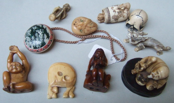 Appraisal: A group of netsuke comprising a study of a cat