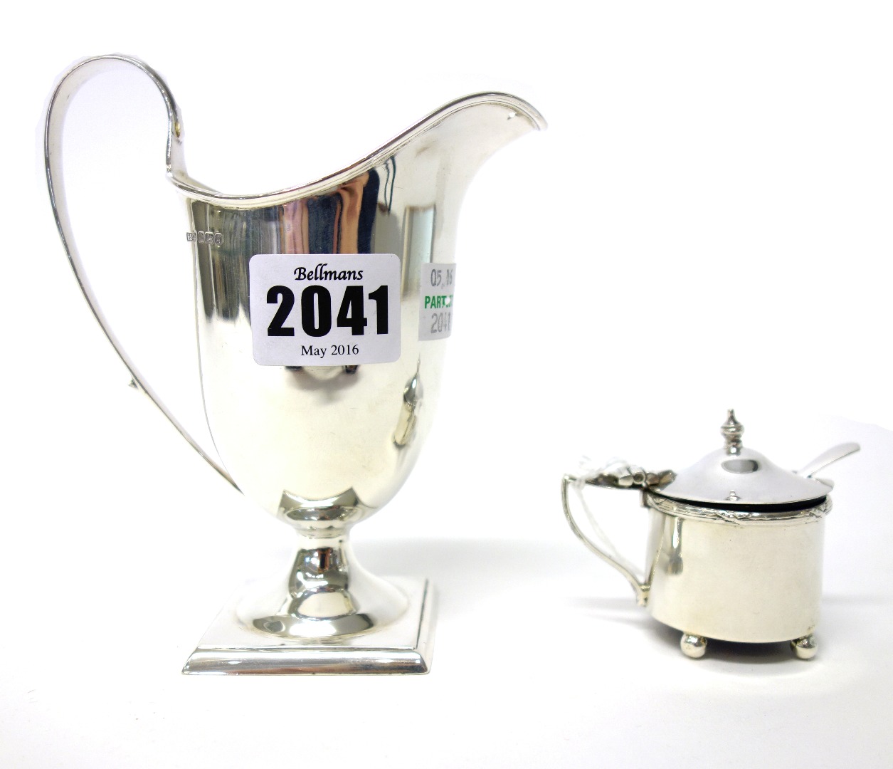 Appraisal: A silver helmet shaped milk jug raised on a square