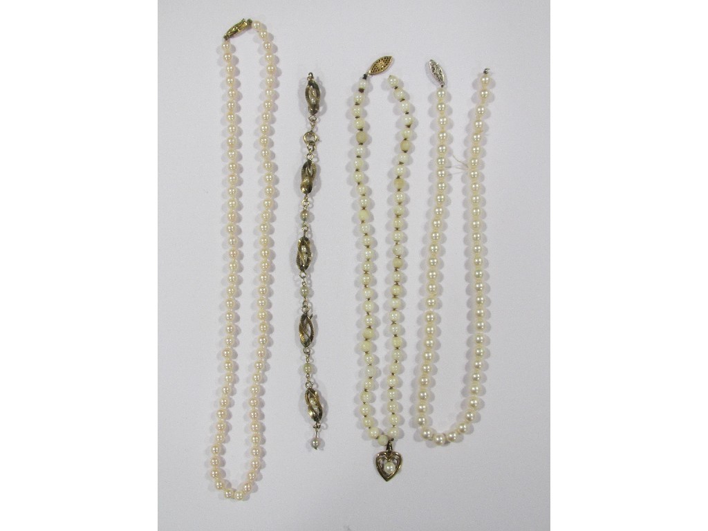 Appraisal: Three strings of cultured pearls and a yellow metal cultured