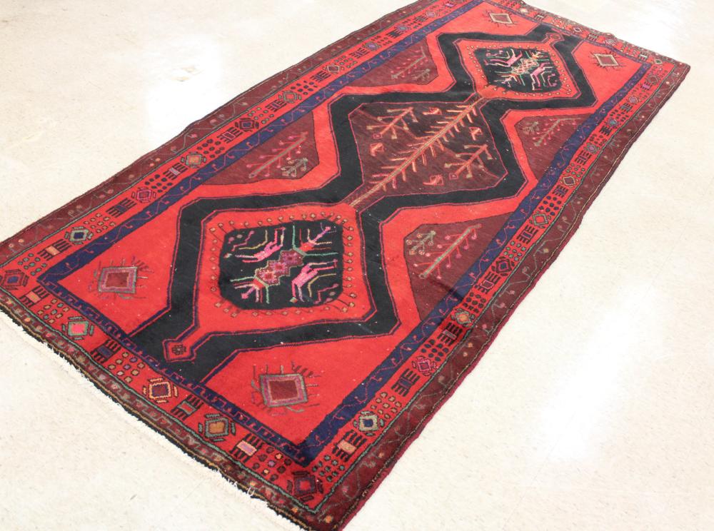 Appraisal: HAND KNOTTED PERSIAN TRIBAL RUG triple pole medallions design on