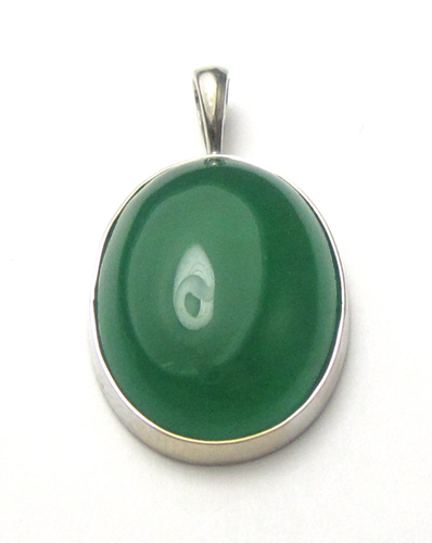 Appraisal: JADE AND FOURTEEN KARAT WHITE GOLD PENDANT set with an