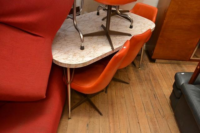 Appraisal: A LAMINATE TOP DINING TABLE WITH EIGHT ORANGE VINYL UPHOLSTERED