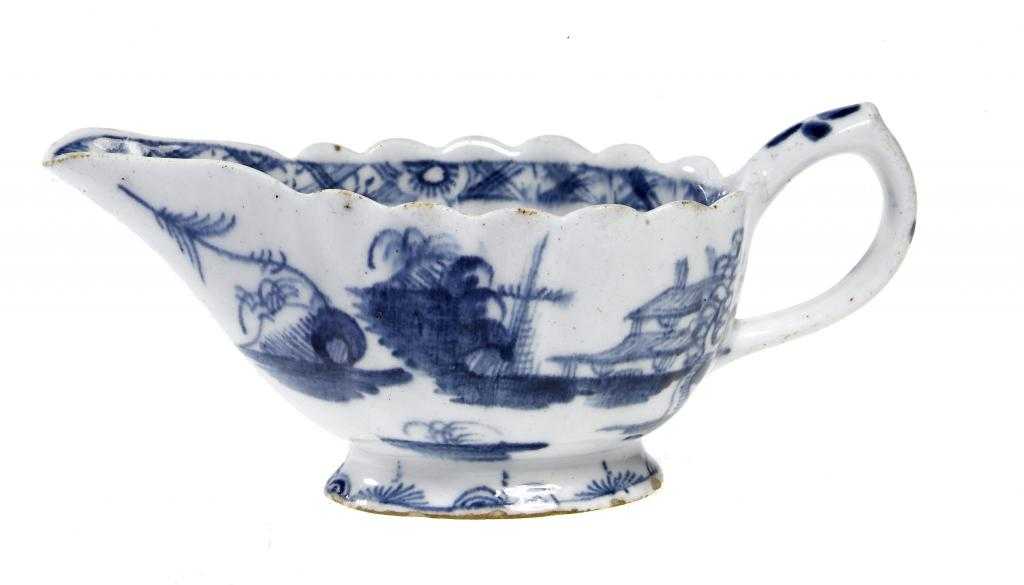 Appraisal: A BOW CREAMBOAT of reeded form painted in underglaze blue