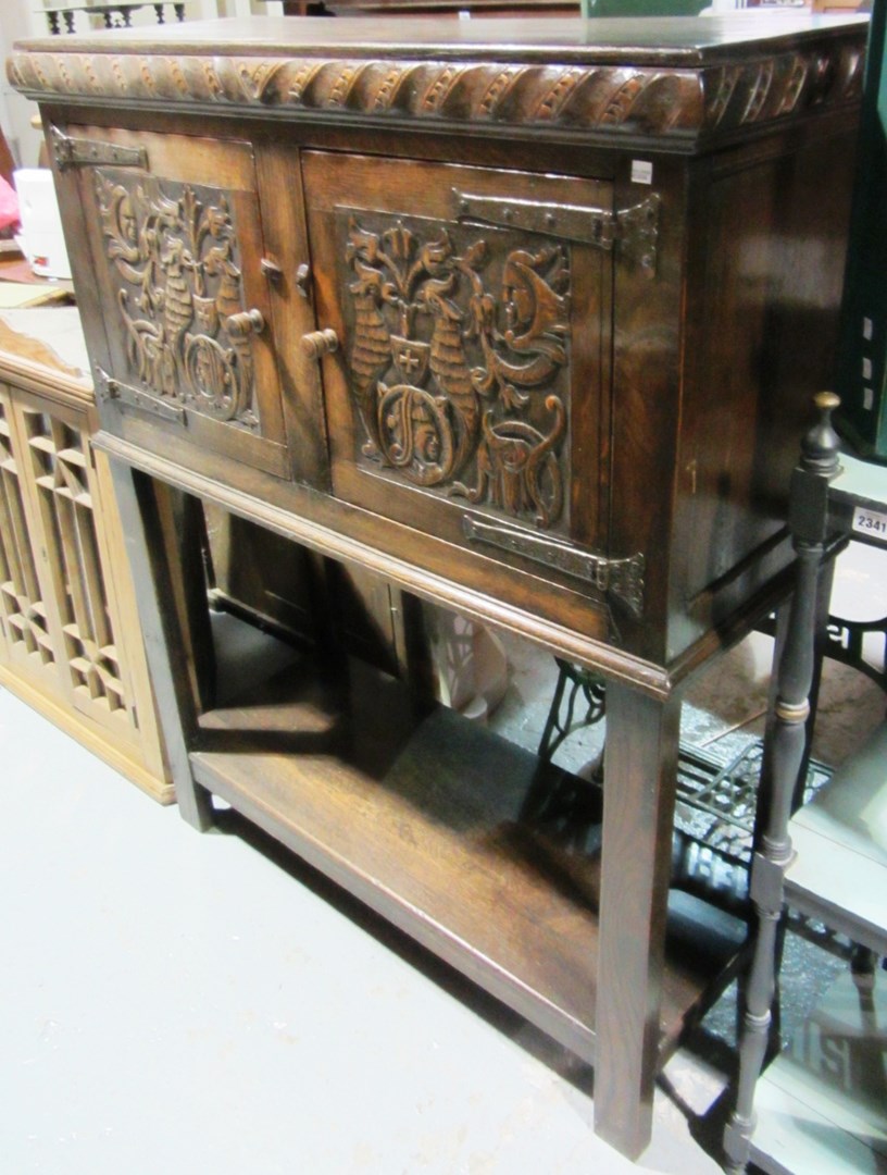 Appraisal: A th century carved oak two door cupboard with pot