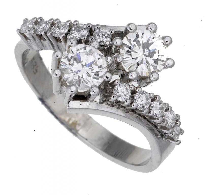 Appraisal: A DIAMOND CROSSOVER RING each evenly sized diamond heading a