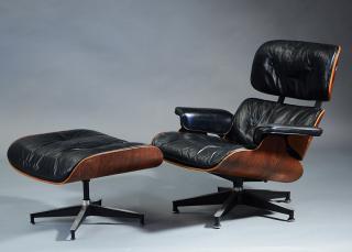 Appraisal: Herman Miller black leather and rosewood chair and ottoman Herman