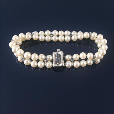 Appraisal: A two row cultured pearl bracelet set with ten small