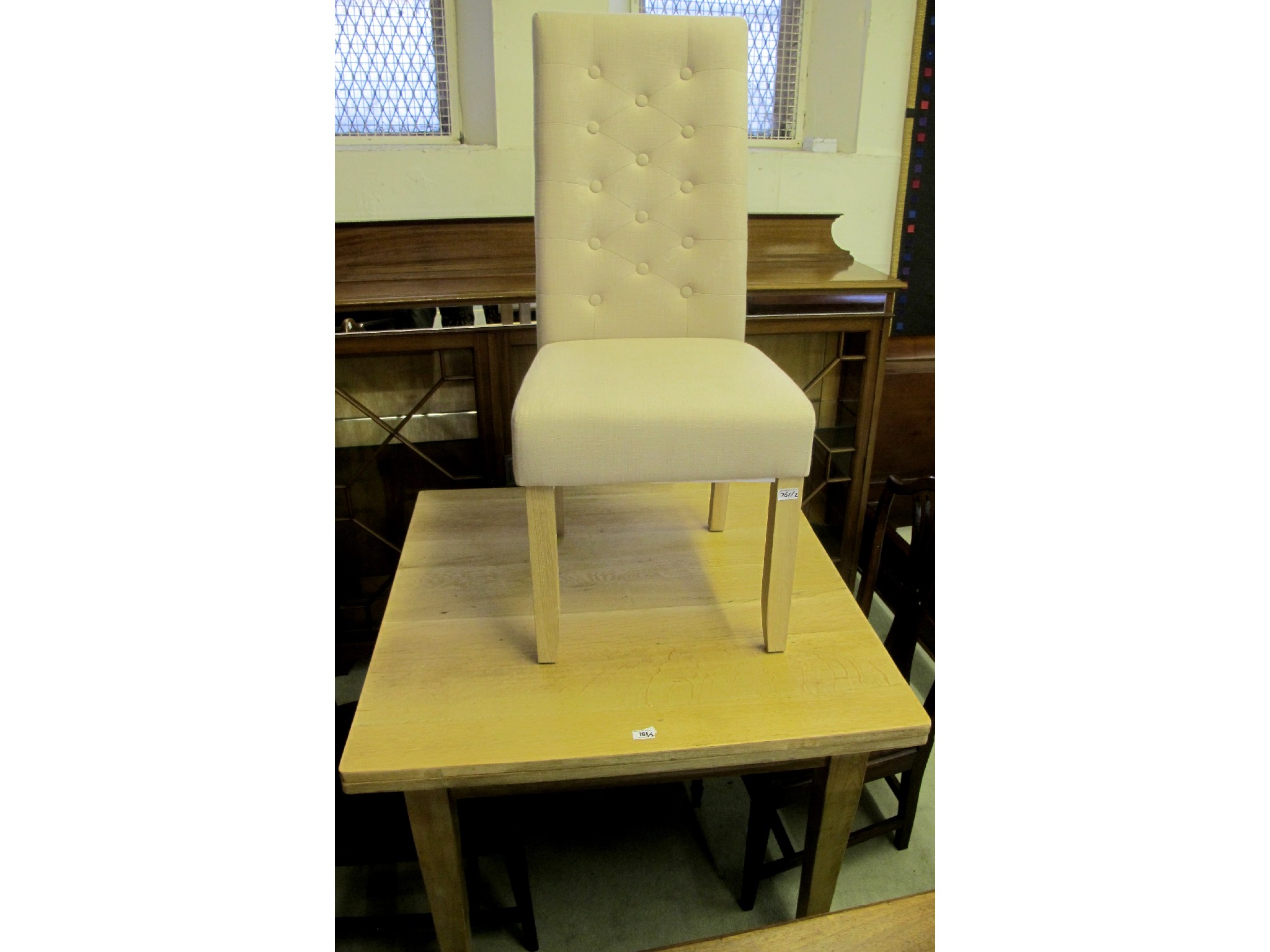 Appraisal: A striped oak extending dining table and a beige button