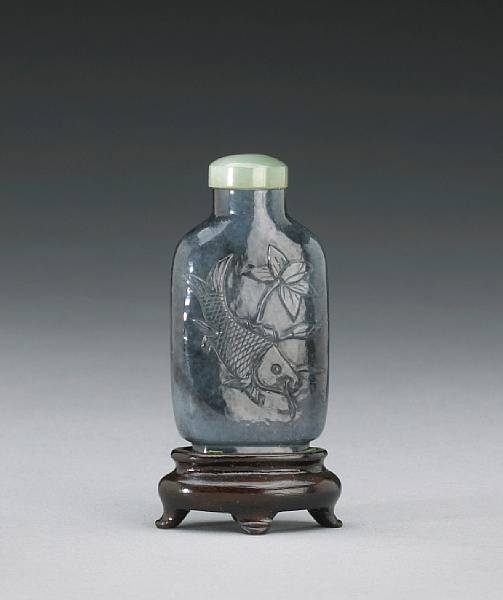 Appraisal: A gray jade snuff bottle Carved in subtle relief to