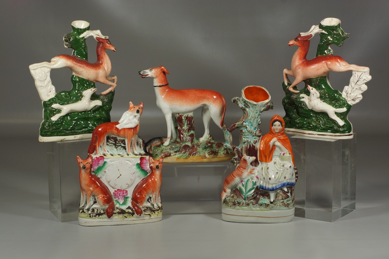 Appraisal: Staffordshire figurines spill vases with greyhounds foxes stags tallest