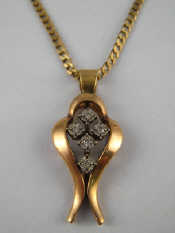 Appraisal: A carat gold diamond pendant with carat gold chain pendant