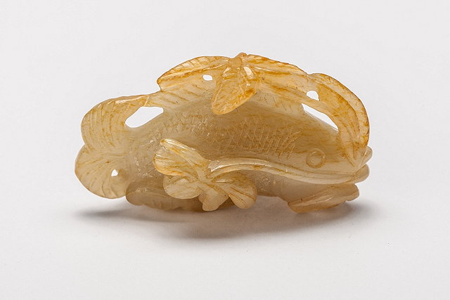 Appraisal: A CHINESE JADE CARVING of a fish and leaves two