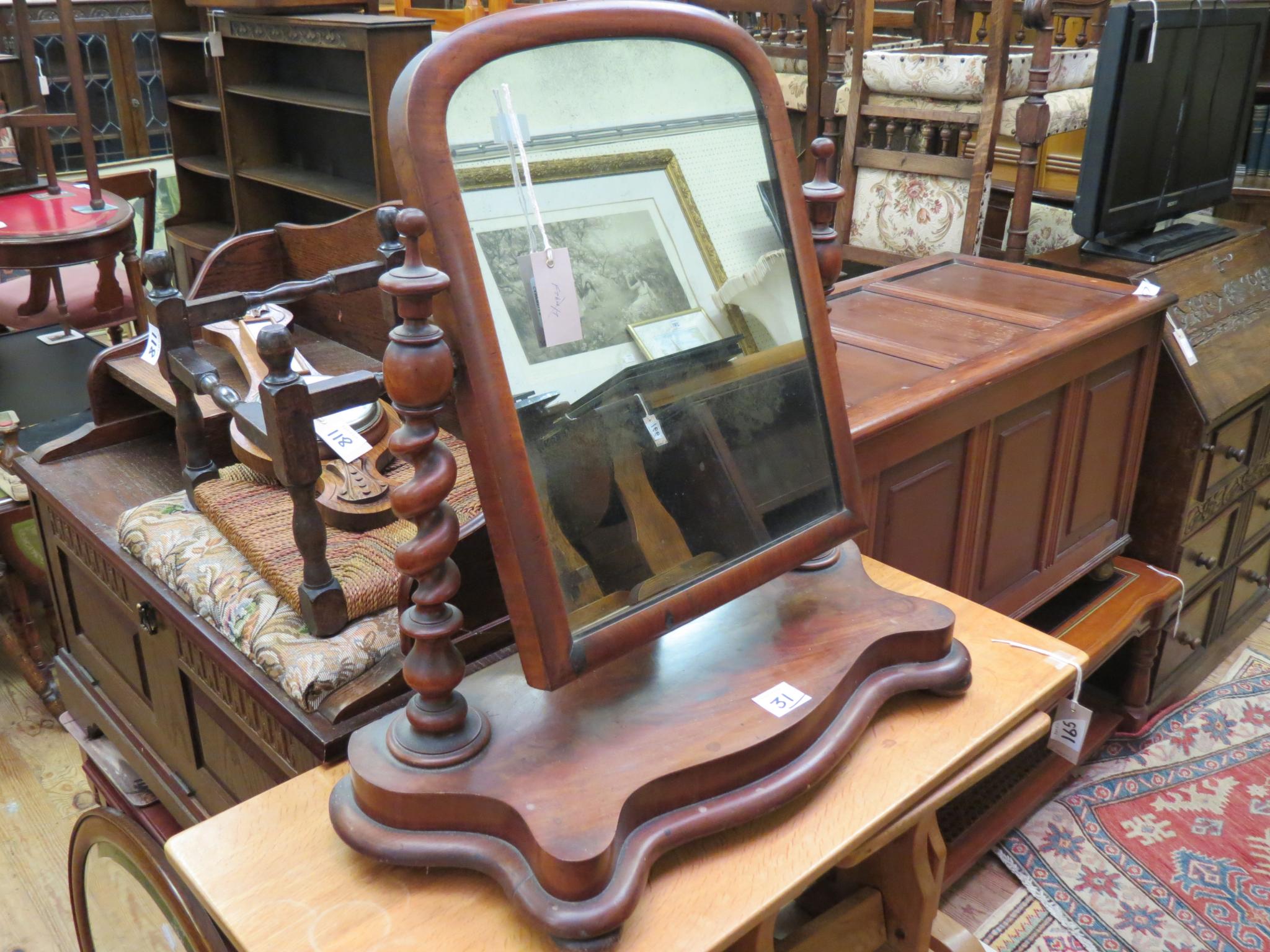 Appraisal: A Victorian mahogany toilet mirror adjustable on spiral-twist uprights and