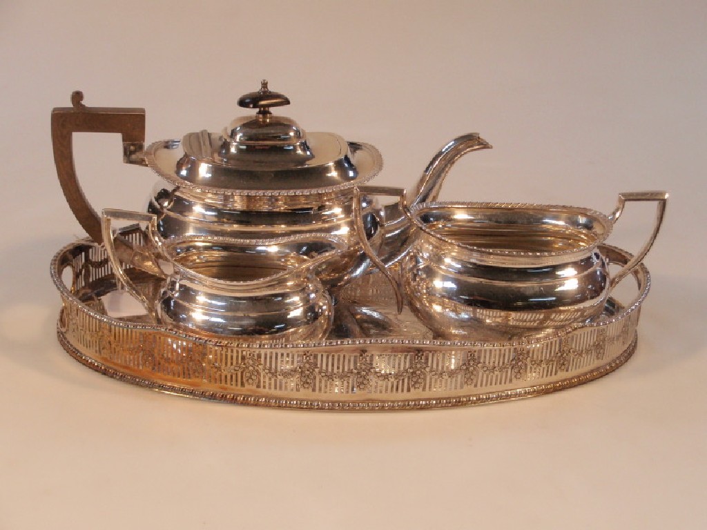 Appraisal: An electroplated three-piece tea service of classical form with gadroon