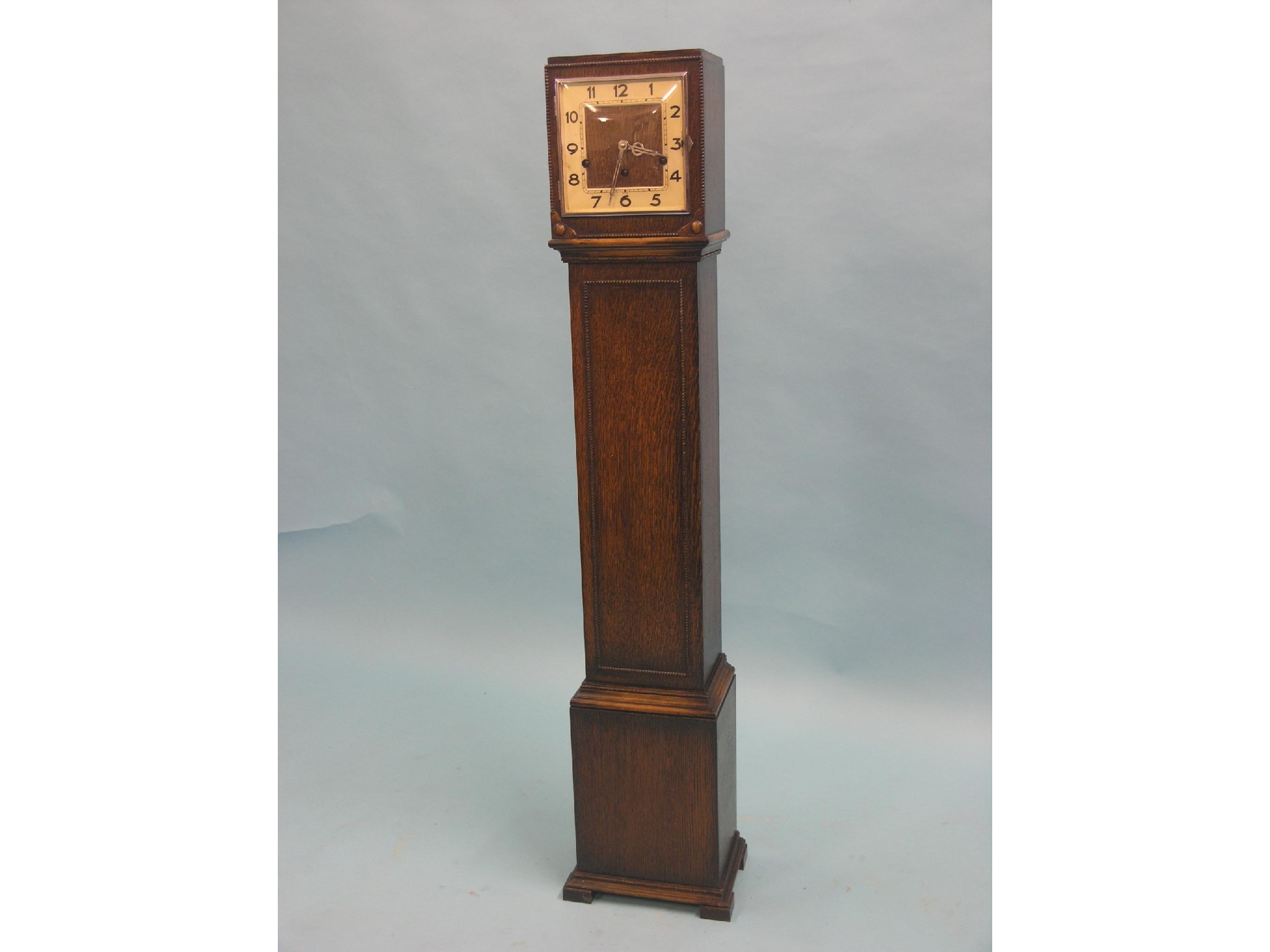 Appraisal: A dark oak-veneered grandmother clock with square dial and German