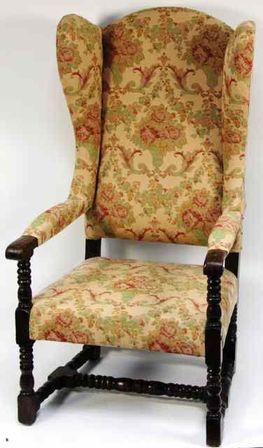 Appraisal: A th Century style upholstered wing armchair on turned legs