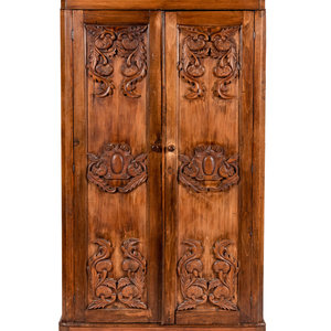 Appraisal: A Mexican Carved Wardrobe Mid th Century with carved doors