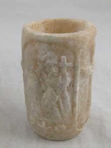 Appraisal: An ancient carved alabaster beaker with relief carved images of