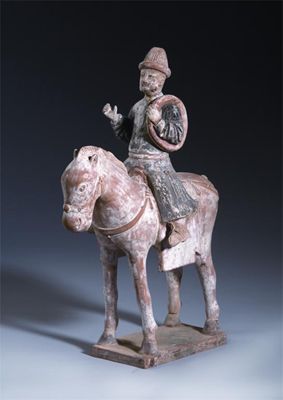 Appraisal: A Chinese unglazed pottery equestrian figure raised on a rectangular