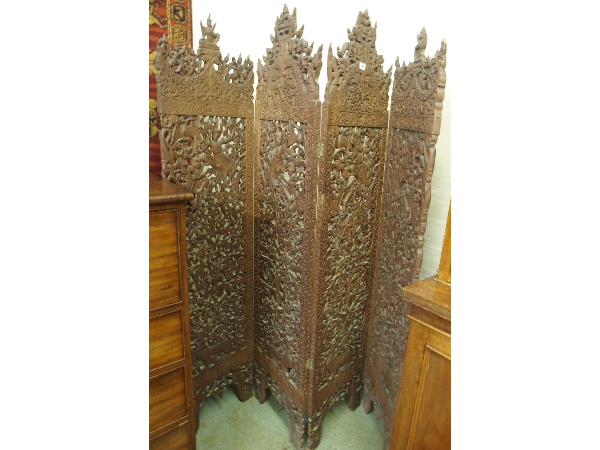 Appraisal: A Burmese four fold carved hardwood screen