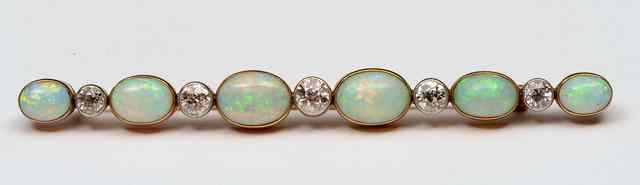 Appraisal: AN OPAL AND DIAMOND BAR BROOCH six graduated oval opals