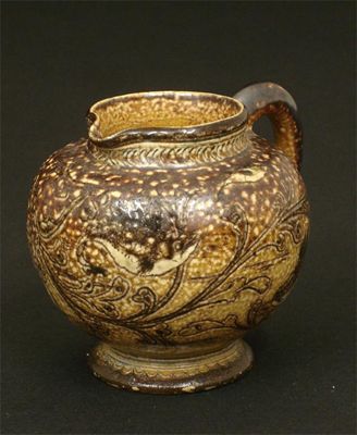 Appraisal: A Martin Brothers stoneware jug incised with grotesque fish amongst