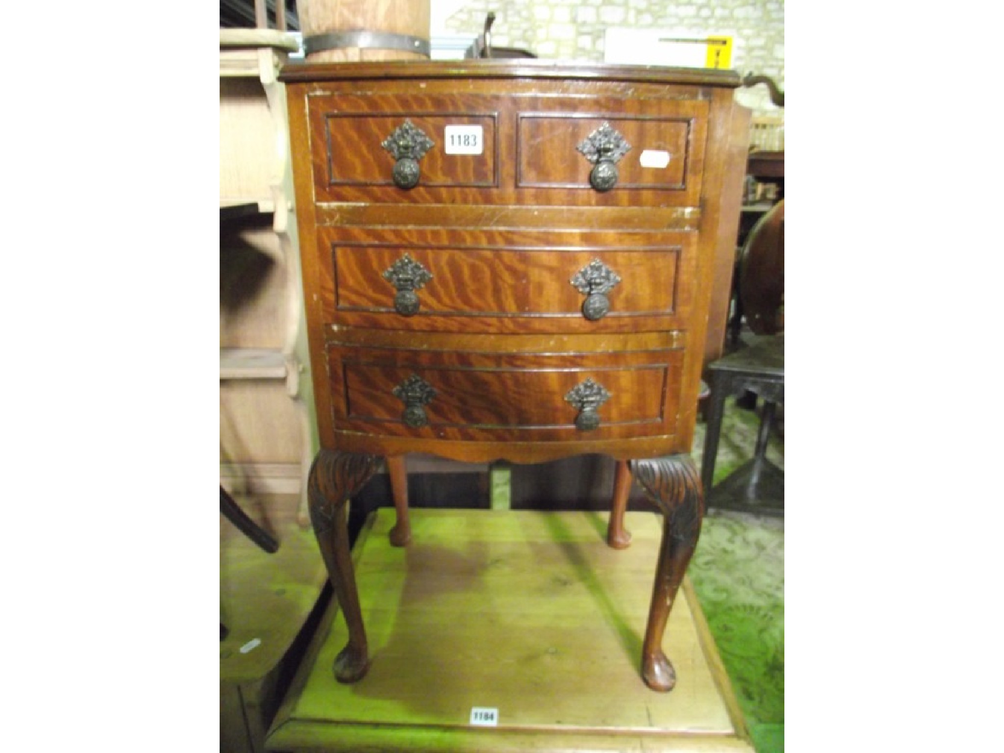 Appraisal: A small reproduction bow fronted bedside chest in the Georgian