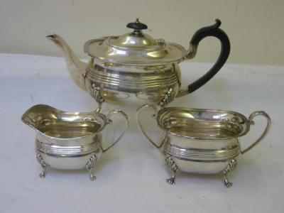 Appraisal: A THREE PIECE TEA SERVICE of rounded rectangular form with