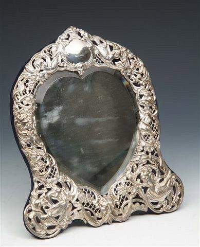 Appraisal: A SILVER EASEL DRESSING TABLE MIRROR of heart shaped form