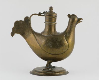 Appraisal: An Islamic brass ewer modelled as a cockerel incised with