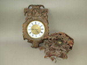 Appraisal: A Continental wooden cased wall clock with carved decoration the