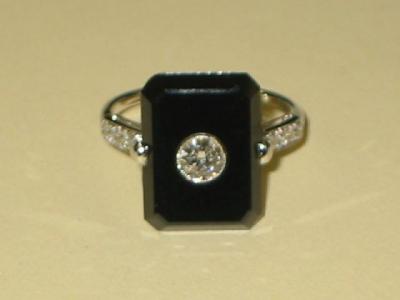 Appraisal: AN ONYX AND DIAMOND RING in the Art Deco style