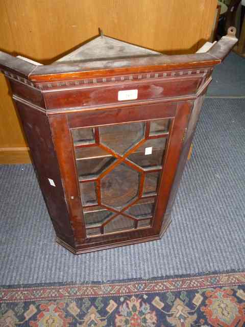 Appraisal: A TH CENTURY MAHOGANY CORNER CABINET the multi panelled glazed