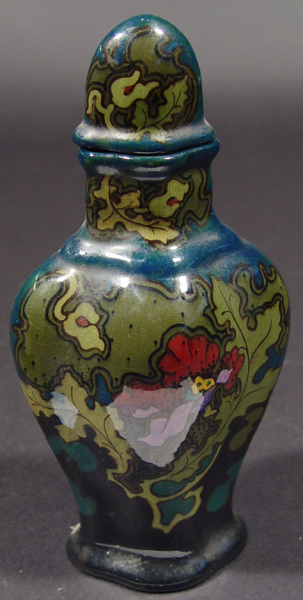 Appraisal: Gouda vase and cover hand painted with stylised flowers onto